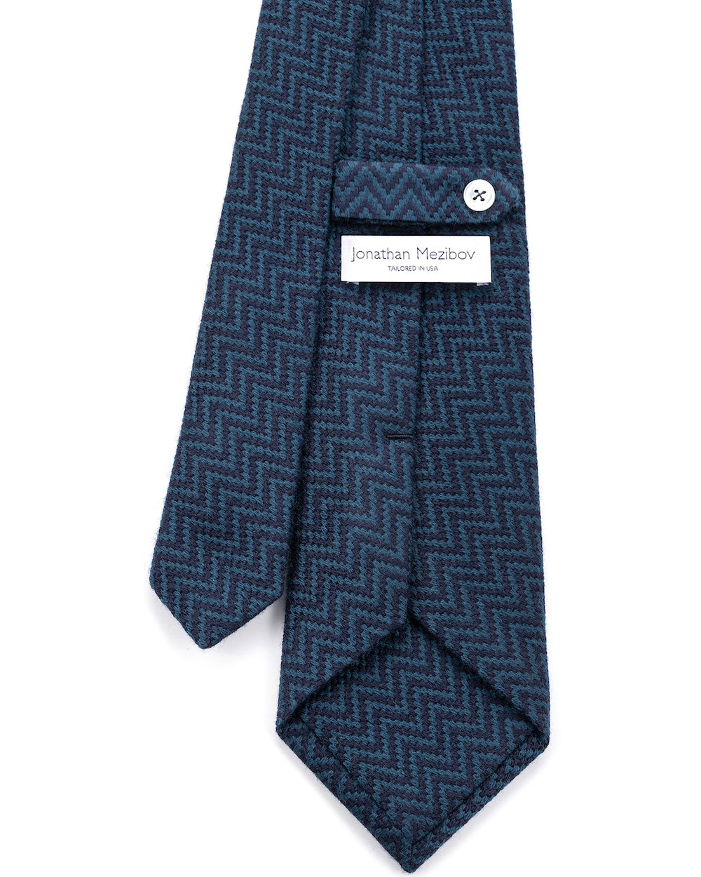 Close-up of the signature tab keeper loop on the Jonathan Mezibov Zigzag Wool-Silk Tie.