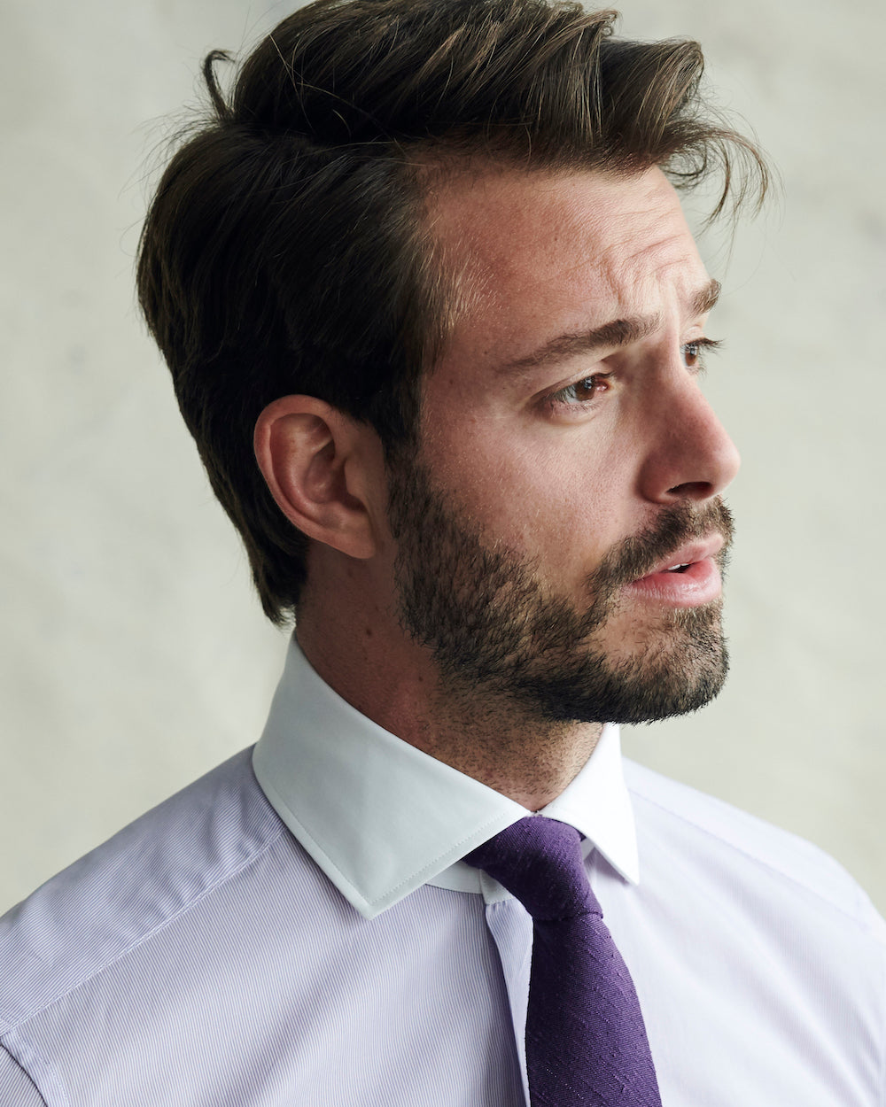 Male model wearing the Carmichael Fine Striped Shirt and iris Solid Raw Silk Tie.