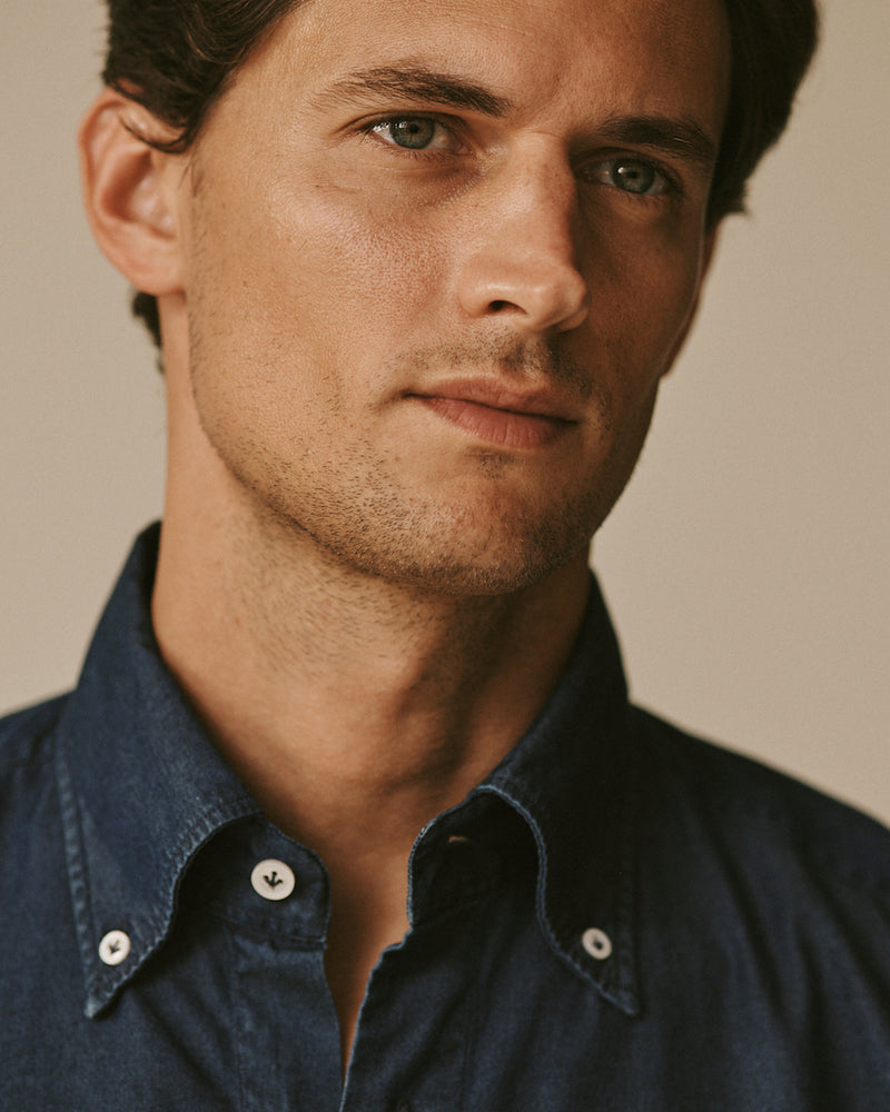 Close-up of a male model wearing the button-down Gordon Denim Shirt.