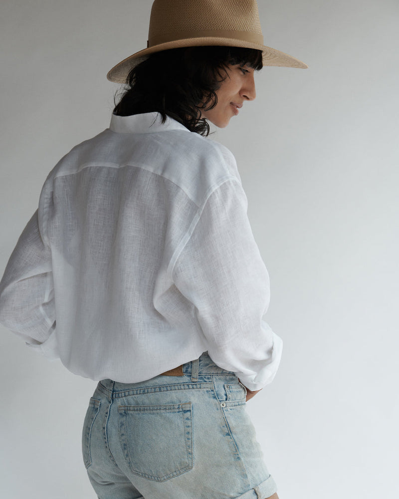 Back view of a female model wearing the Band Collar Linen Shirt.