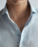 Close-up of the front placket and cutaway collar on the light blue Pearson Linen Shirt.