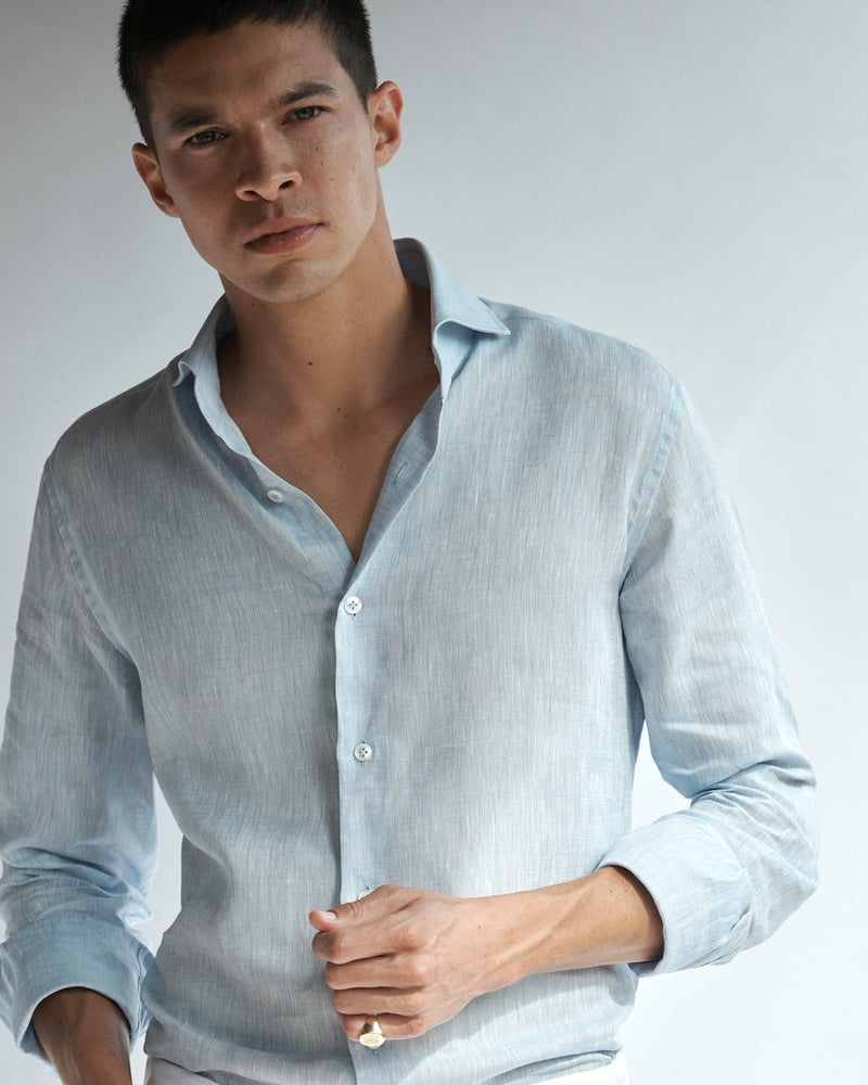 Close-up of a male model wearing the light blue Pearson Linen Shirt.