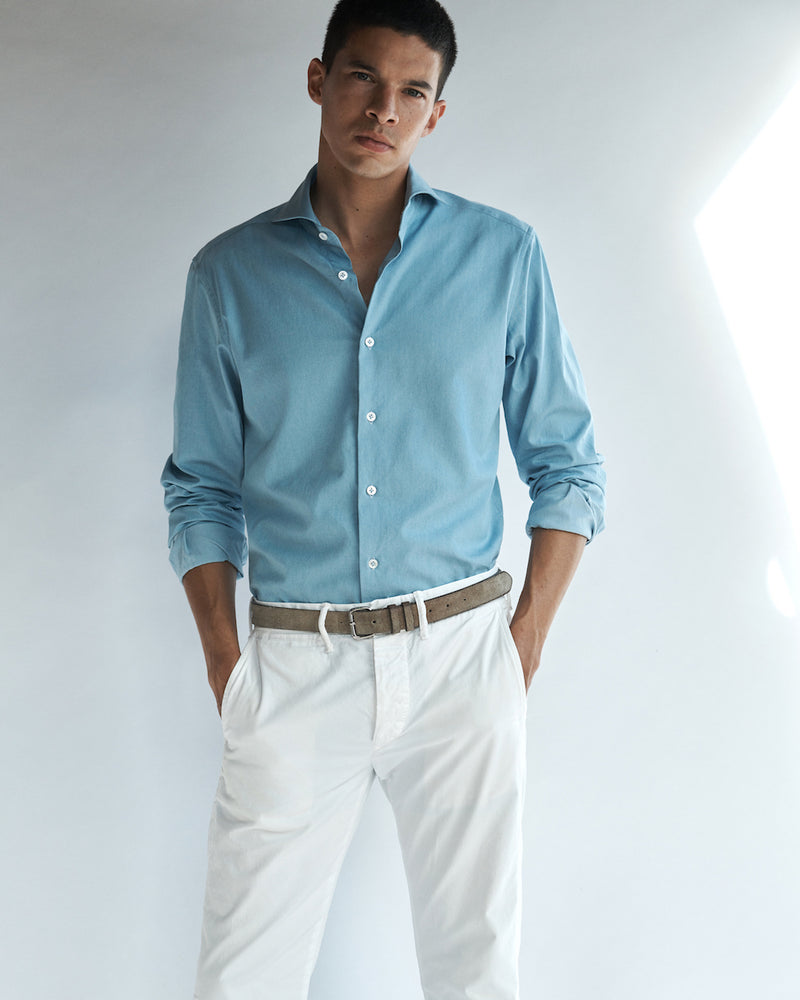 Male model wearing the Pearson Bleached Denim Shirt and cotton chinos.