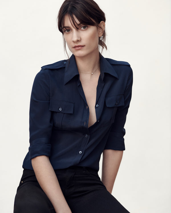 Female model wearing the Jonathan Mezibov navy Silk Crepe de Chine Military Shirt, made in Italy.
