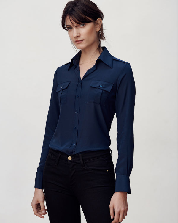 Female model wearing the Jonathan Mezibov navy Silk Crepe de Chine Military Shirt and jeans.