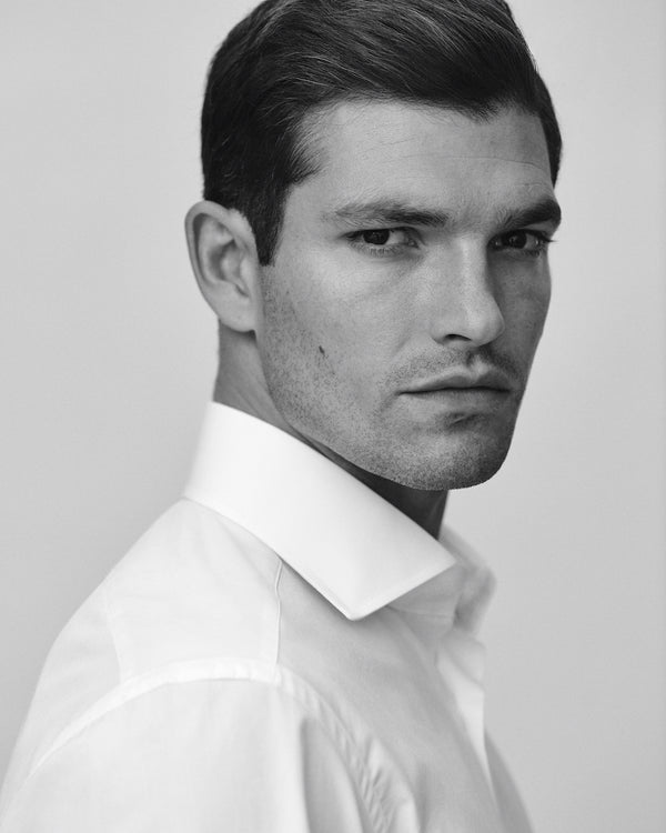 Close-up of a male model wearing the Carmichael Poplin Shirt.